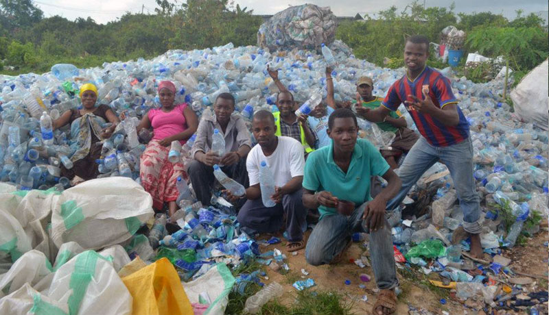 Scuba Do Zanzibar with Greenhouse Recycling team in the mountain of plastics about to be shredded