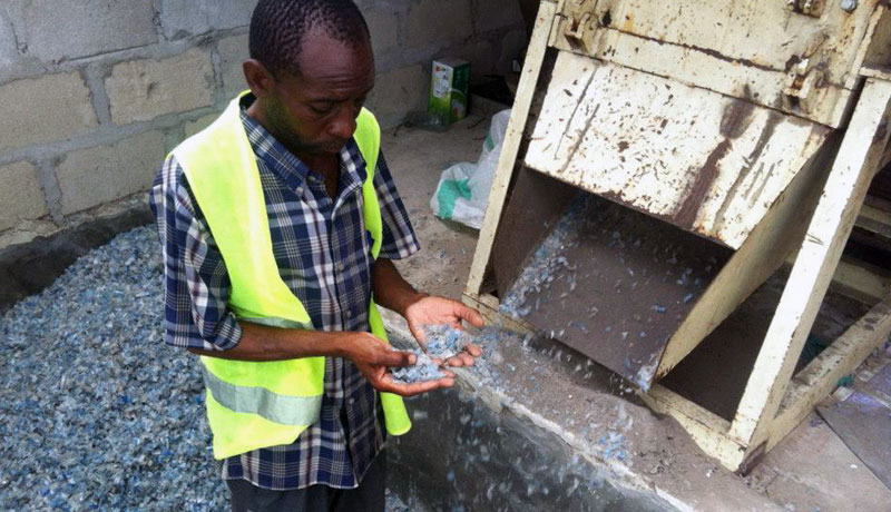 Checking the recycled plastic after being shredded