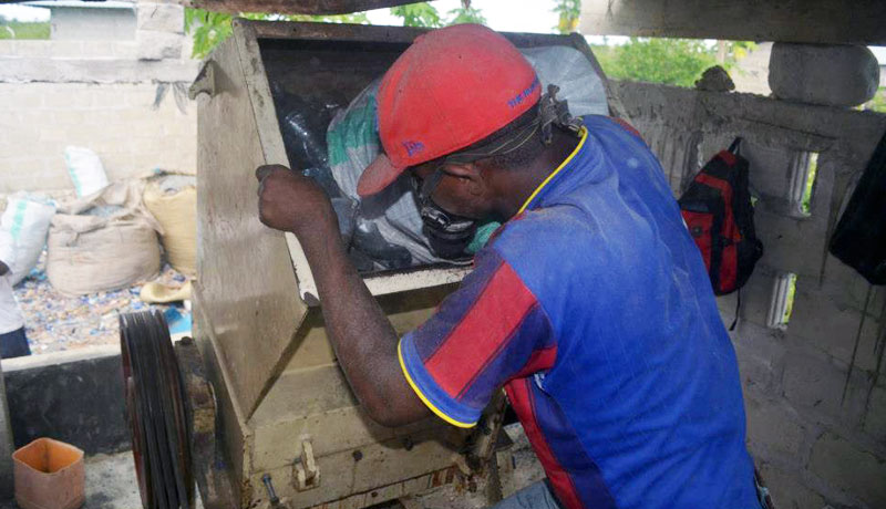 Putting plastics into the recycling shredder in Nungwi Zanzibar