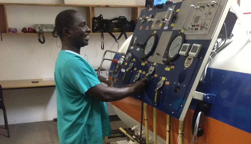 Scuba Do Zanzibar's Instructor Haji dressed in medical scrubs operating the hyperbaric chamber while we were treating an injured diver