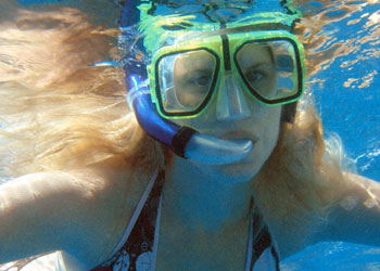 Happy snorkeller in clear water over Kendwa Reef