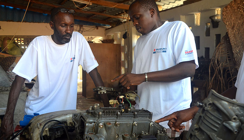 Inspecting Suzuki Marine engine in preparation for rebuild for training purposes