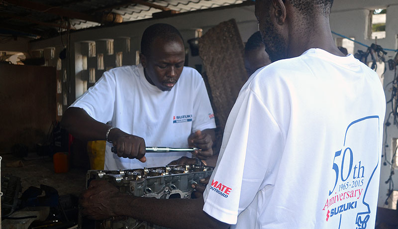 Demonstrating correct torque settings while rebuilding Suzuki Marine engines for training purposes